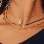 What are the benefits of purchasing necklaces signedde by well-known designers?